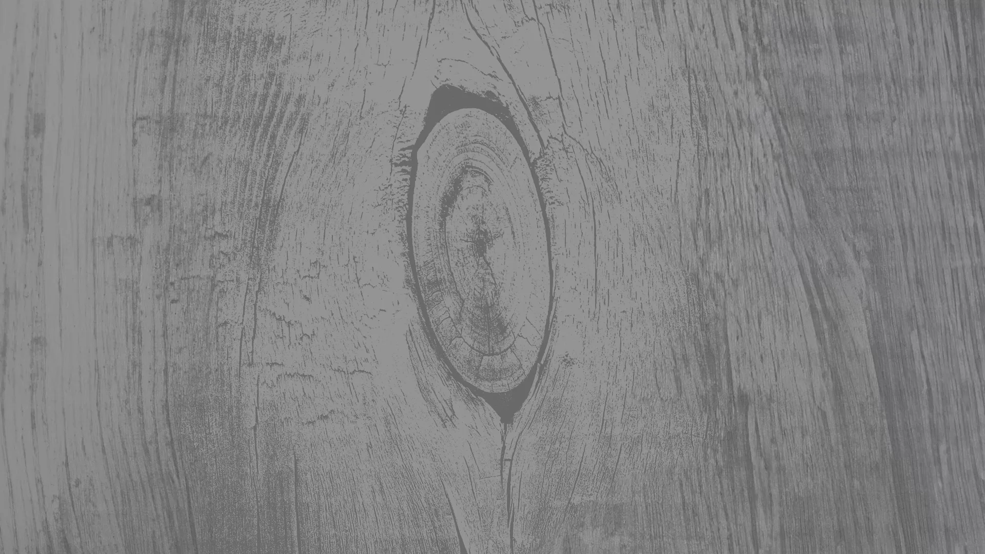 Close-up photo of light grey woodgrain texture.